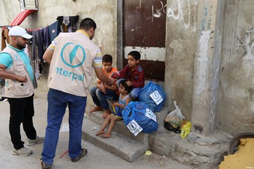 Interpal staff distribute aid to Palestinian refugee children
