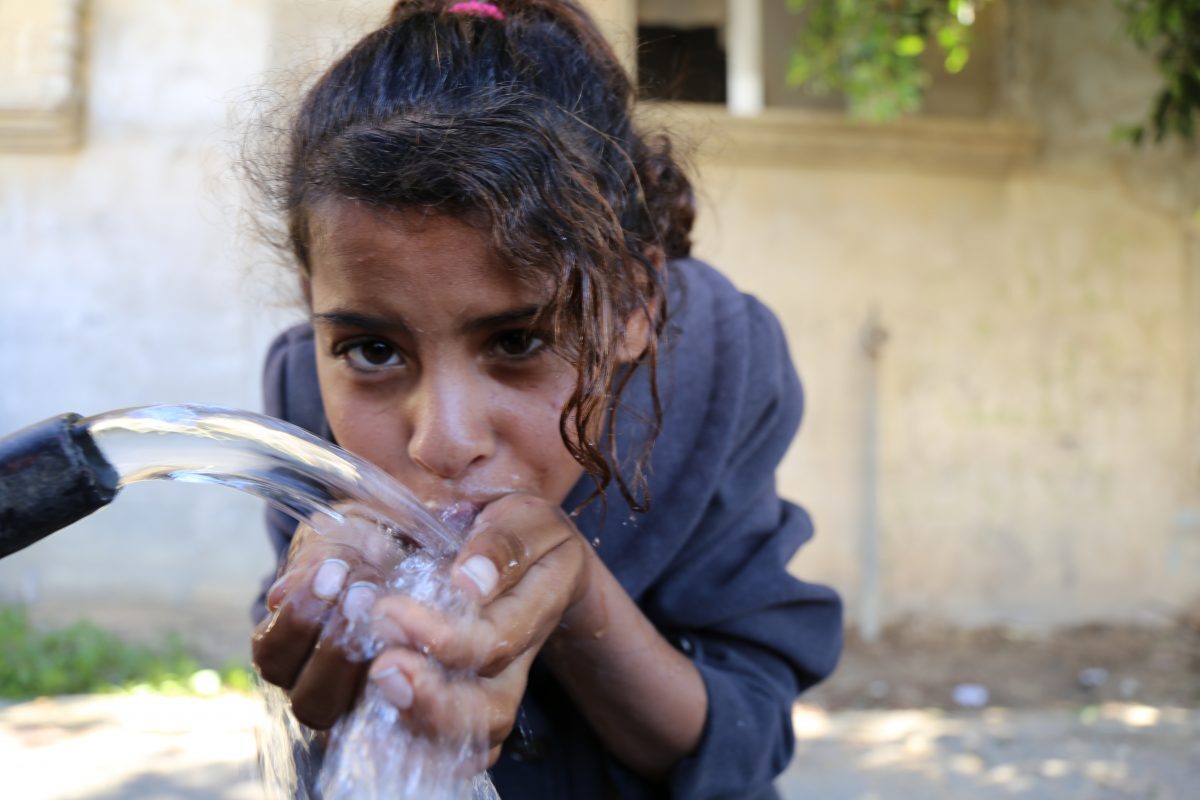 Palestinian girl drinks clean water